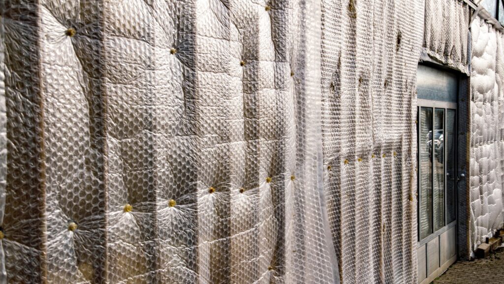 Exterior view of a building insulated with bubble wrap sheets
